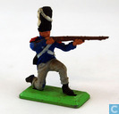 Soldier kneeling and shooting