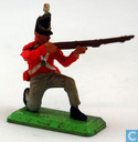 Soldier kneeling and shooting