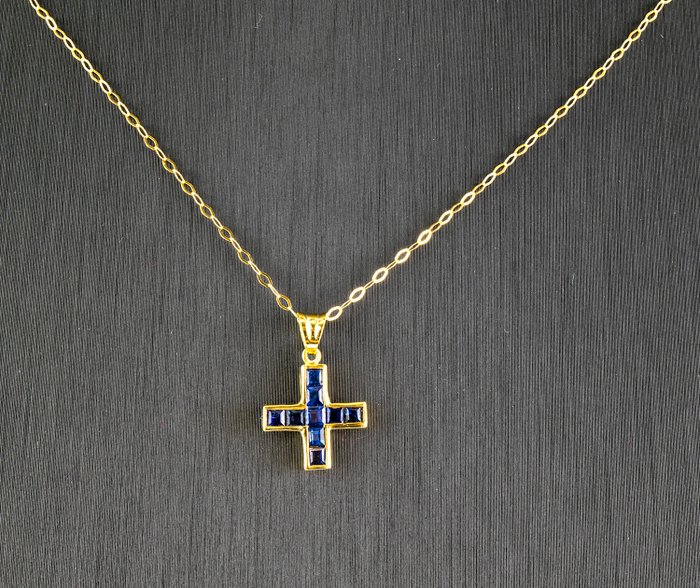 Yellow gold necklace and yellow gold cross set with sapphires.
