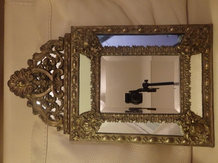 Mirror framed with bezels, France. Embossed brass with wood. End of the 19th century.

