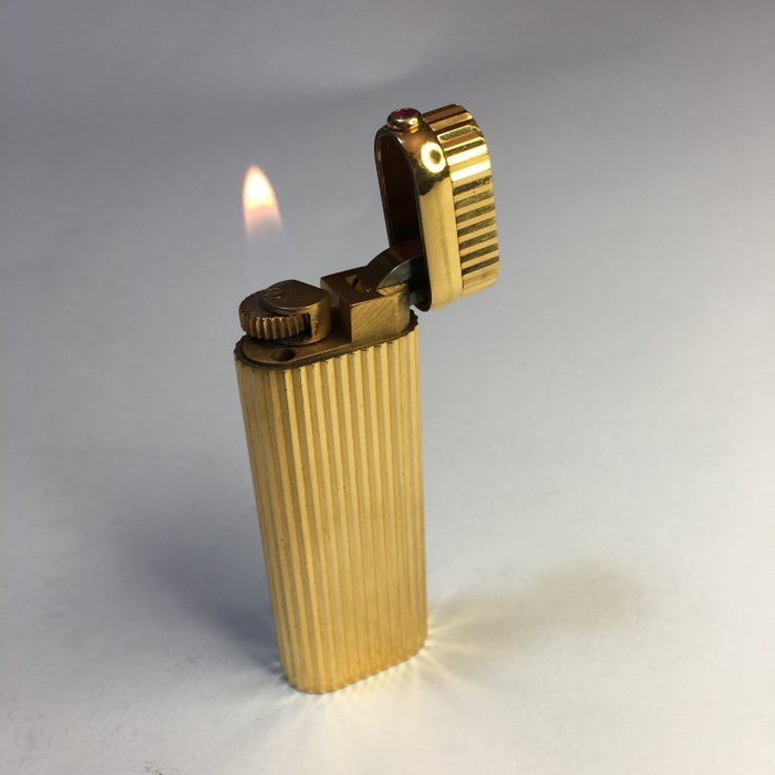 Oval Cartier lighter with box, approx 