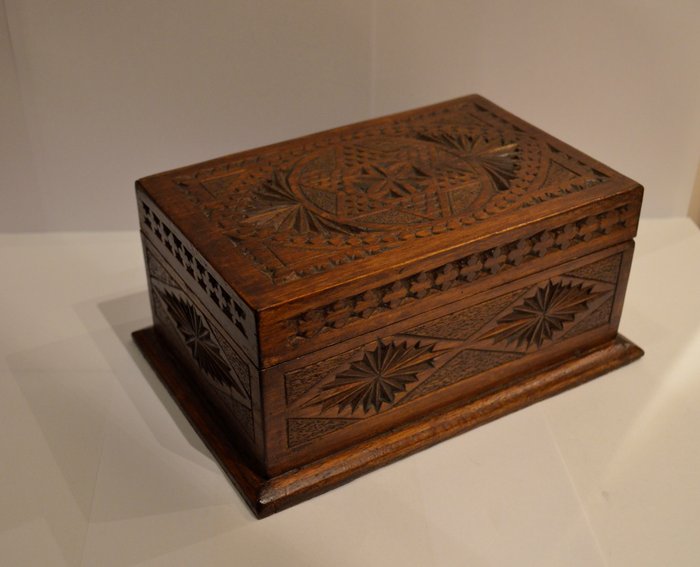 Antique wooden box with a beautiful carved decor with a star of David on the lid.