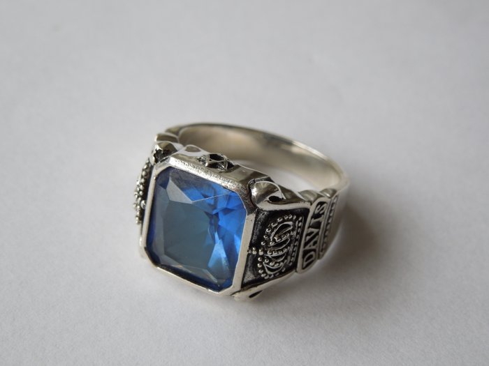 Silver men's signet ring with a cut blue aquamarine stone