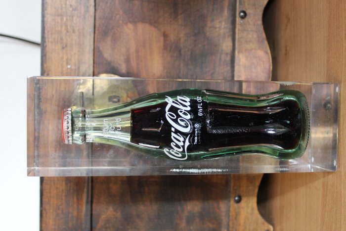 Original old Coca Cola bottle in a block of acryl