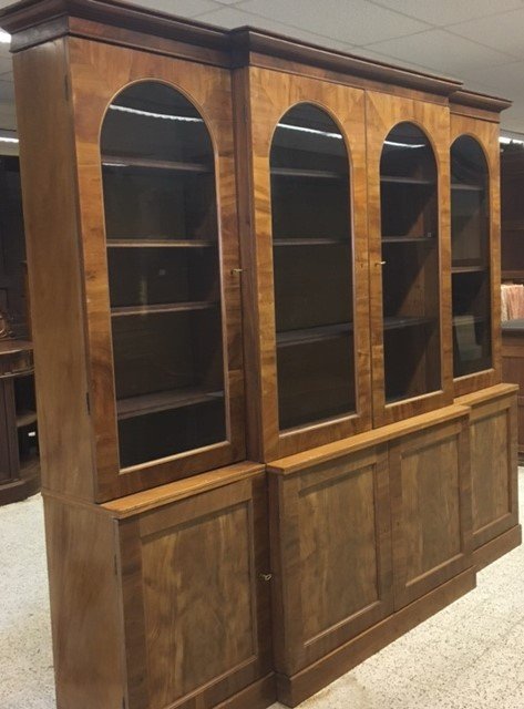 An Edwardian Walnut Breakfront Bookcase With Arched Glass Doors