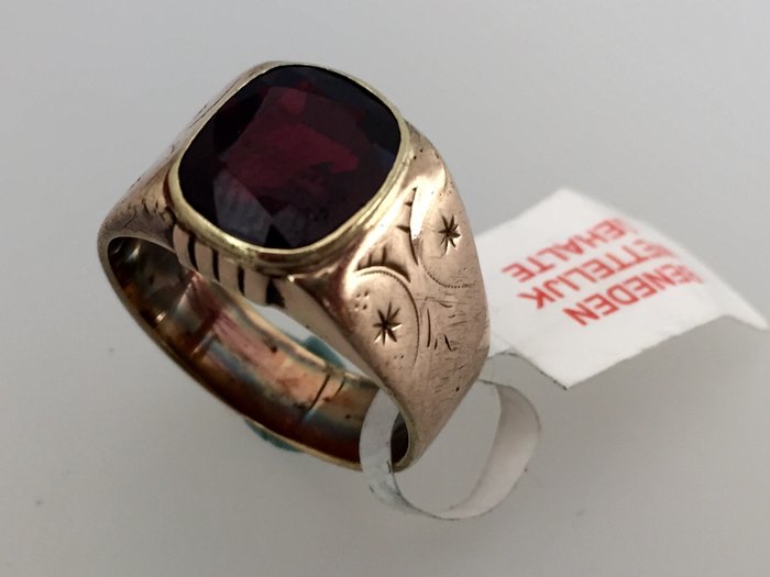 Antique men's ring with a garnet stone.