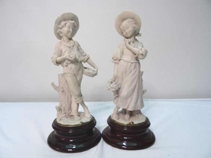 Giuseppe Armani porcelain figurines of a boy and girl, 20th century

