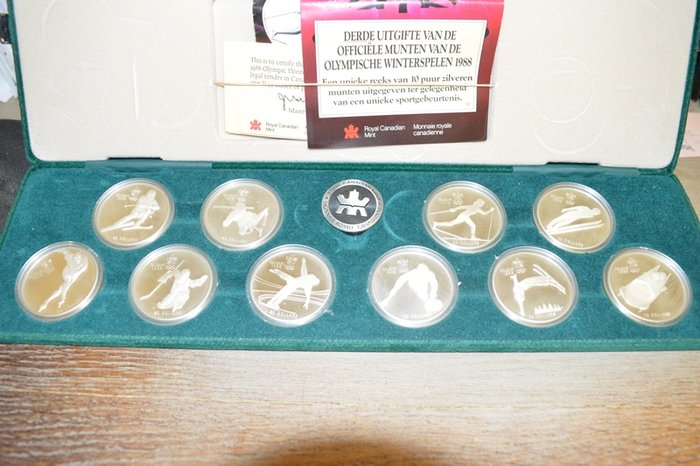 Cofre con 10 monedas diferentes de plata de 20 dólares canadienses, año 1988. Tema: Juegos Olímpicos de Calgary.
