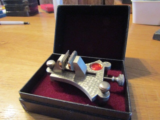 Watchmaker's tools: balance poising tool, tapping bench, glass press, micrometre, rubies, NOS pocket watch cases
