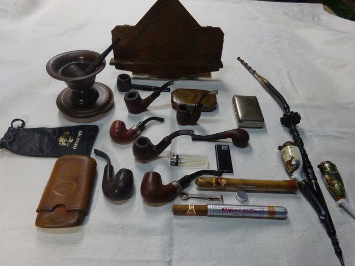 Collection of pipes, smoking articles, antique pipe case pipe rack and german pipe.