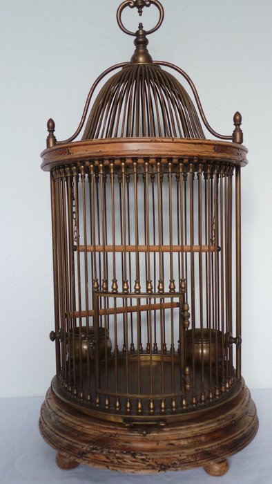 Antique bird cage with wood and a lot of copper