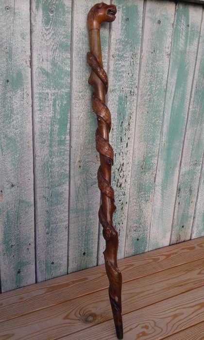 Beautifully carved wooden walking stick, folk art, depicting a snake or Aesculapius, the handle has the shape of a lion's head