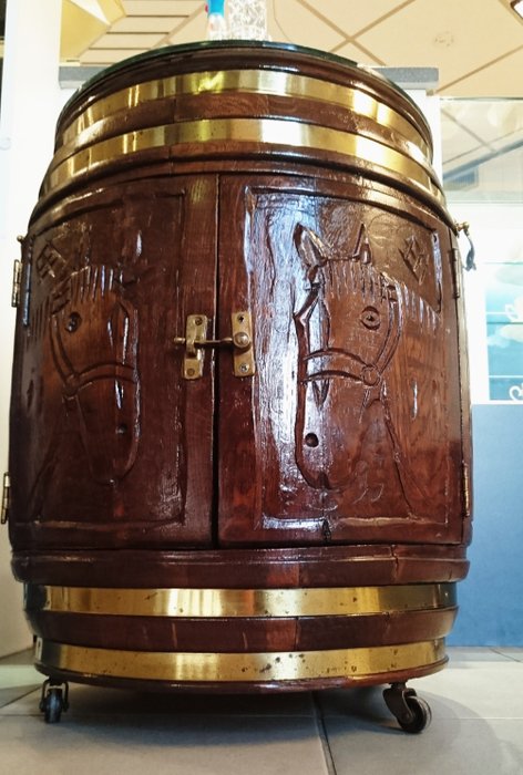 Wooden drinks barrel and bar decorated with copper and a scene of two symmetrical mirroring horse heads