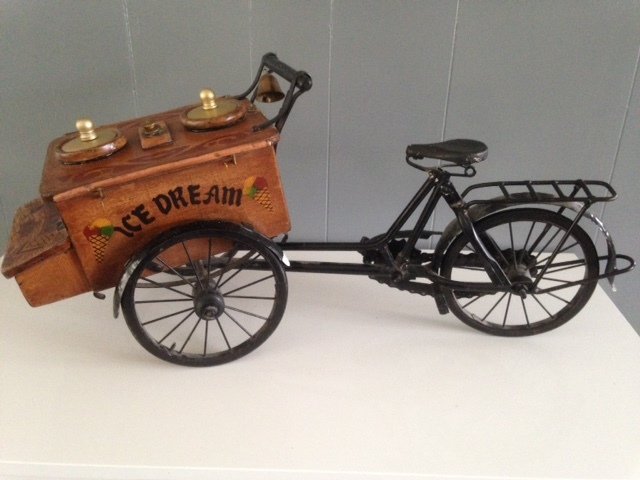 Nostalgic old wooden ice cream cart with bicycle (1940)