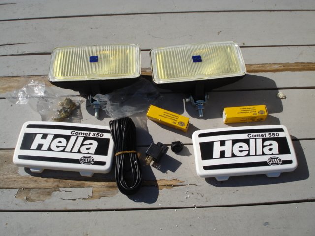 A nice and new set of HELLA COMET 550 Fog lights with protective caps from the 1980s and 1990s