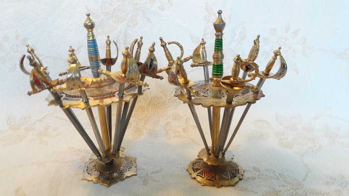 Vintage Toledo cocktail skewers in the shape of swords in beautifully crafted holders - brass, iron, enamel