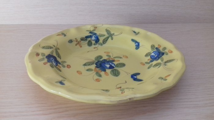 Earthenware plate in yellow background with floral bouquet decoration, Montpellier...