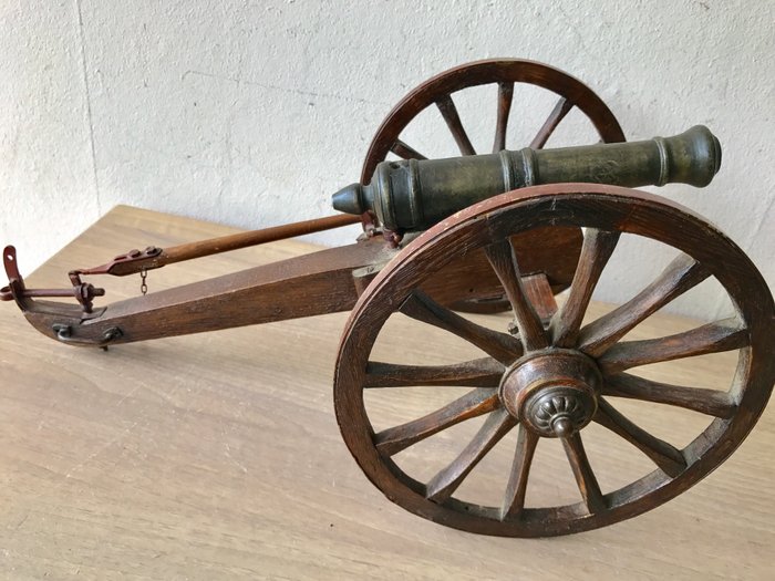 Hand made bronze antique miniature salute cannon on wooden gun carriage with wooden wheels