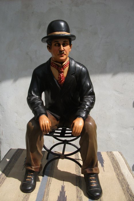 Charlie Chaplin in resin and metal chair