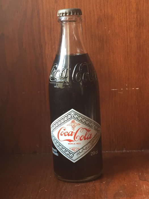 Full bottle of coca cola 1982 in the original packaging of the first bottles of the brand