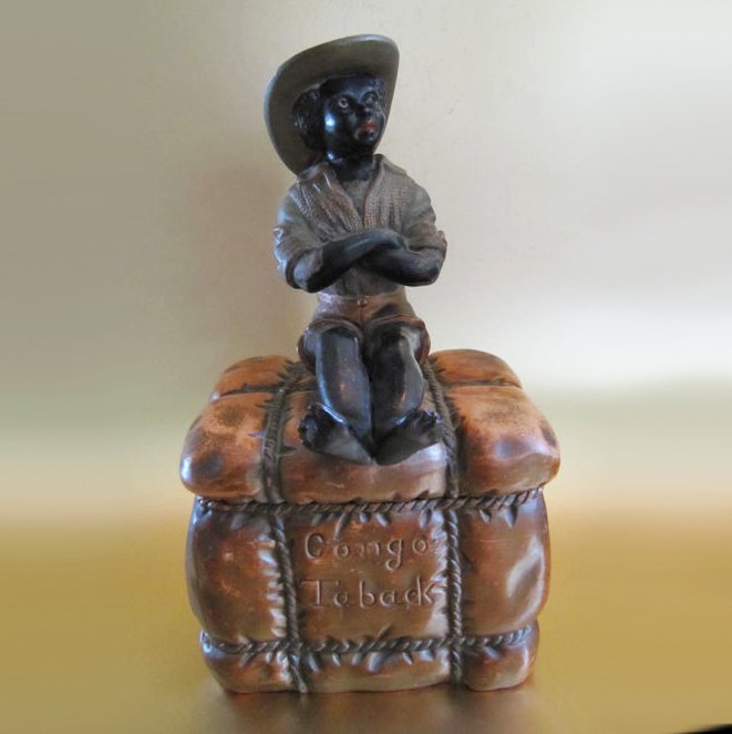 Large figural earthenware tobacco jar ‘sitting black man on a pack of Congo tobacco’ - Bohemia, 1890.