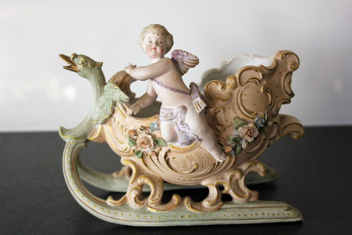 Sled with head of Swan in biscuit with decoration of putto and flowers - France - early 20th century