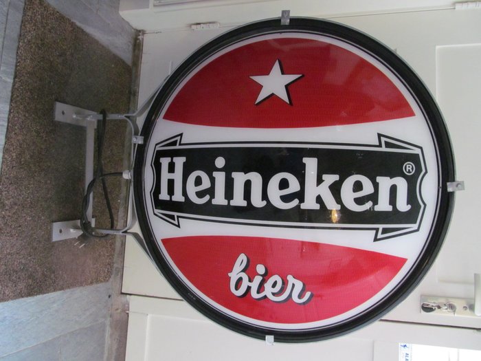 Old Heineken advertising sign, with lighting.