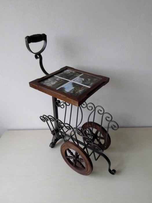 Wrought iron side table with inlaid tiles with Dutch scenes - also a magazine rack on wheels
