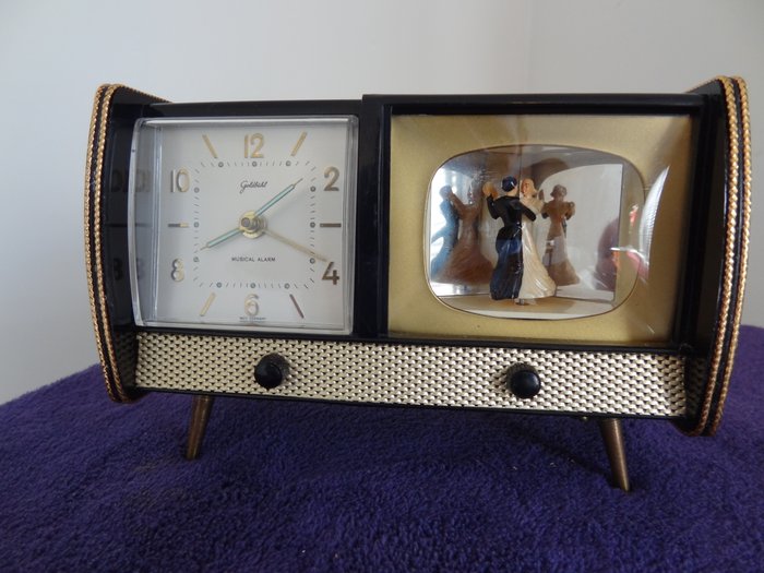 Goldbuhl - Fichter - Uhr mit Spiel Arbeit und Tanzpaar im Fernsehen - Kunststoff und div. Materialien