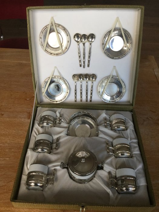 Italian set retro design espresso cup/saucers. The holders are fine porcelain metal chrome plated as well as the saucers and spoons.