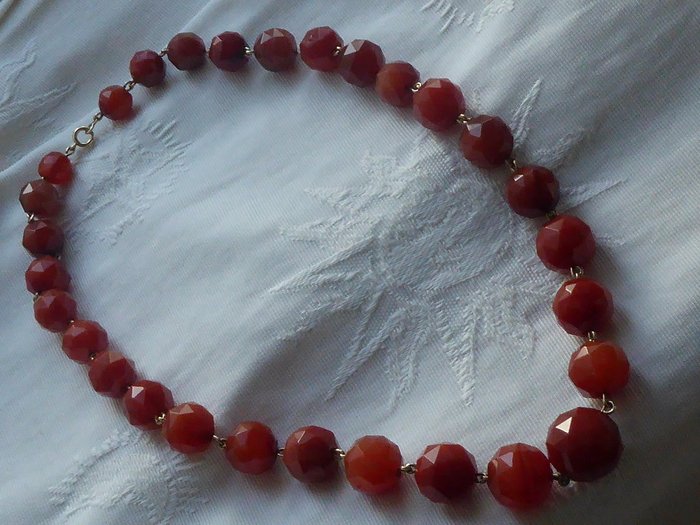 Antique necklace with large facet cut Carnelian beads with gold clasp.