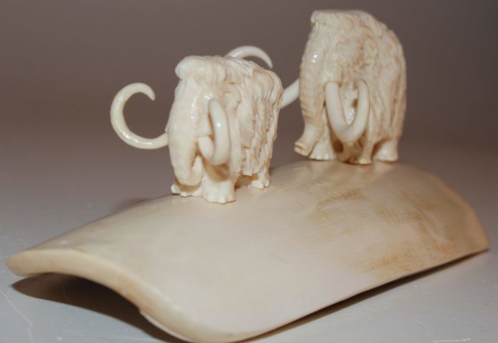 Finely carved Siberian Woolly Mammoth Ivory - 2 carved mammoths set on white mammoth ivory segment - Mammuthus primigenius 