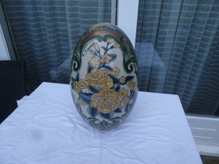 Ceramic egg with floral pattern.