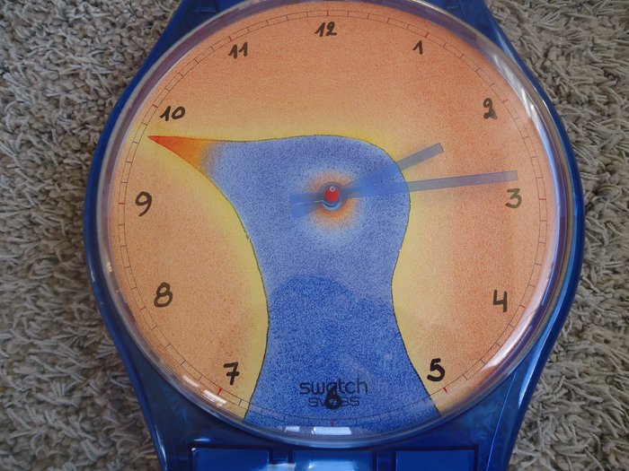 Swatch – wall clock in shape of strongly enlarged watch, drawing Jean-Michel Folon (210 cm long)