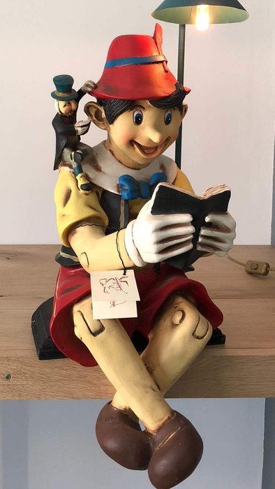Pinocchio reading with Jiminy Cricket