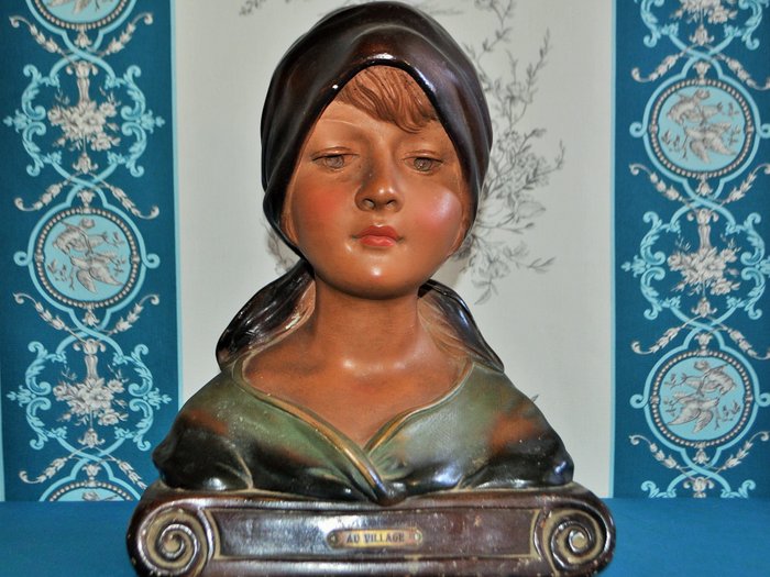 Plaster bust of a young woman titled au village