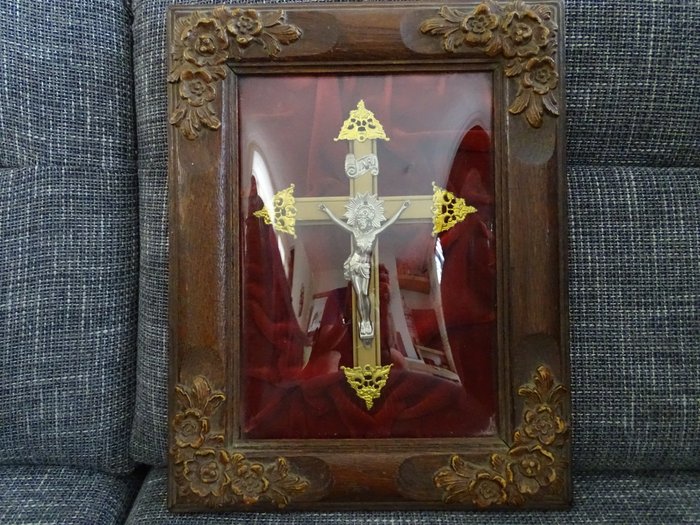 Crucifix behind convex glass with oak frame