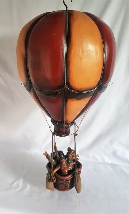 Decorative vintage hot air balloon with people in the basket
