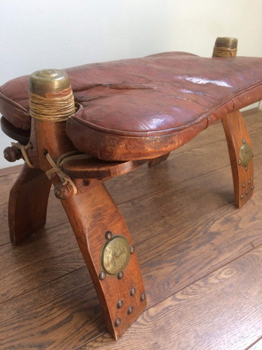 A vintage camel saddle, seat
