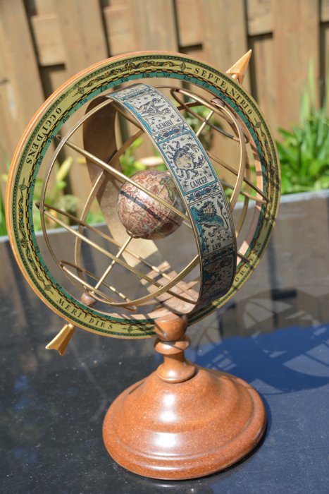 Armillarium / armillary sphere in copper and wood on wooden base