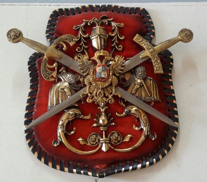 Shield of two crossed swords on red velvet background - Metal alloys twentieth century