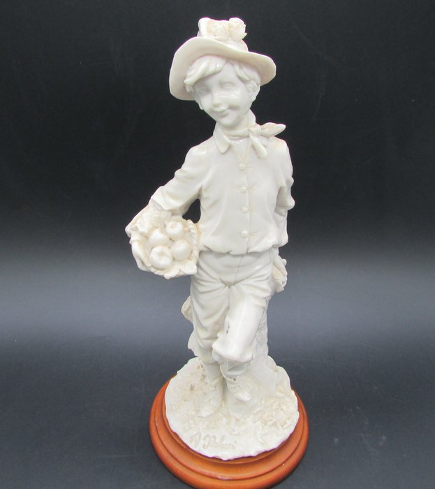 Capodimonte A.Belcari porcelain biscuit figurine - boy with a basket of apples