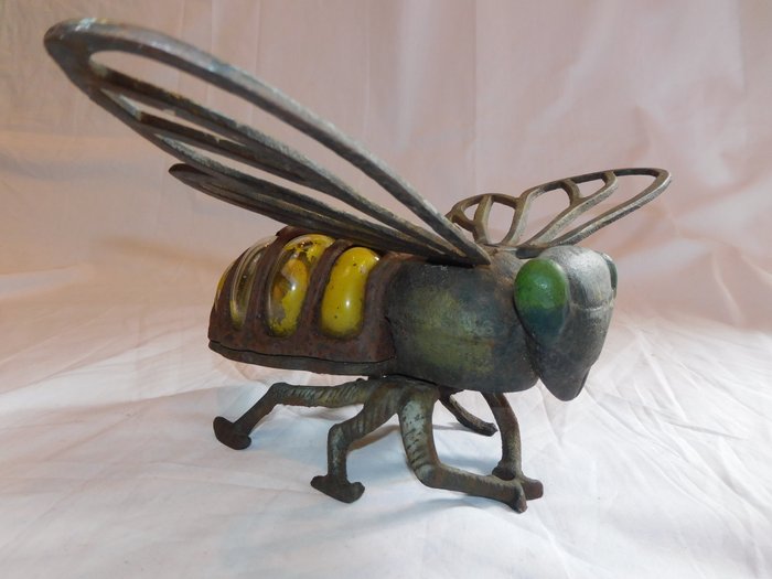 Very large cast iron bee as garden decoration