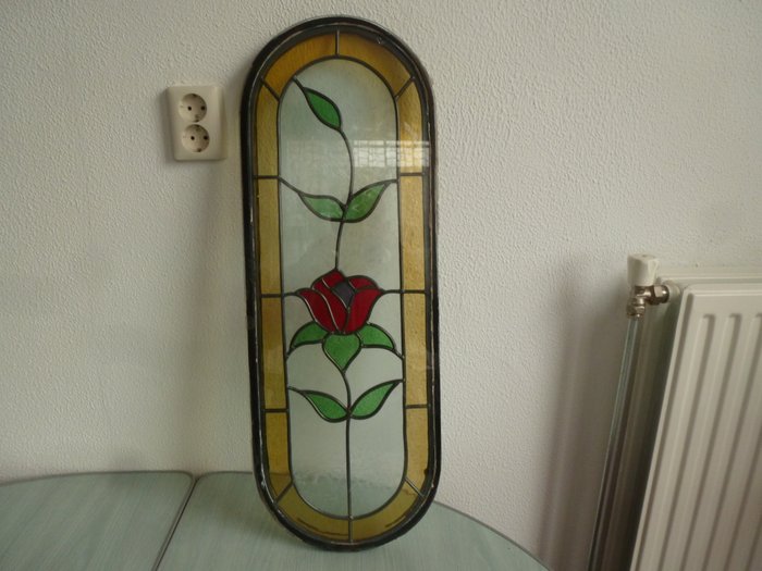 Glass from a door - stained glass between double glazing - rectangular with a round top and bottom - with image of a rose - 1st half of the 20th century