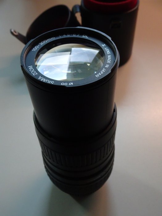 SIGMA ZOOM 100-300mm 1:4.5-6.7 DL with leather lens case - Catawiki