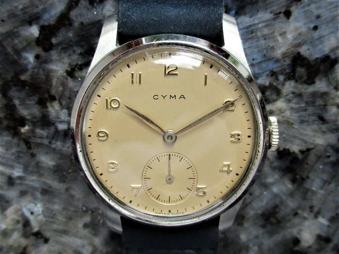 C Y M A (Cyma Watch Co. SA / Tavannes Watch Co.	La Chaux-de-Fonds, SUISSE) - NEW OLD STOCK 032 (Kb) GENTLEMAN'S DRESS WATCH  - 1 3 3 1 7 - 3 7 - 2 5 5 - Miehet - PRE WW2 - CIRCA 1934
