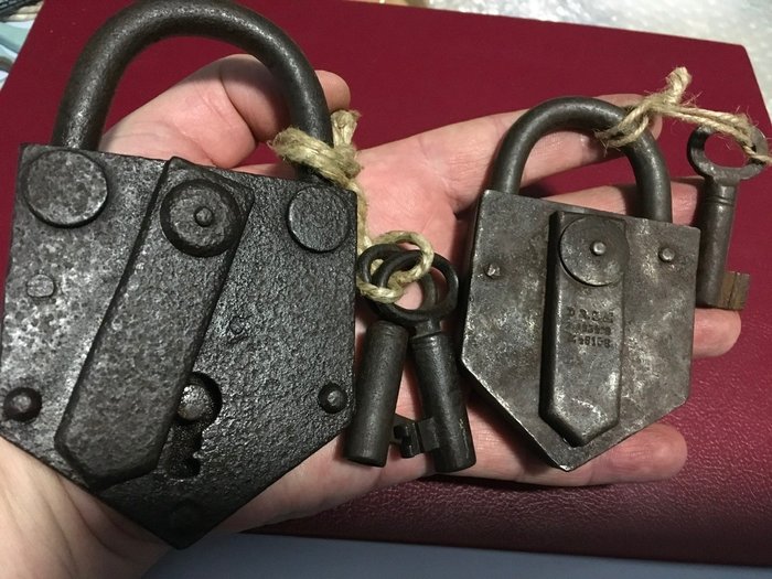 Lot 2 Old padlocks of various sizes and invoices both with working keys (2)