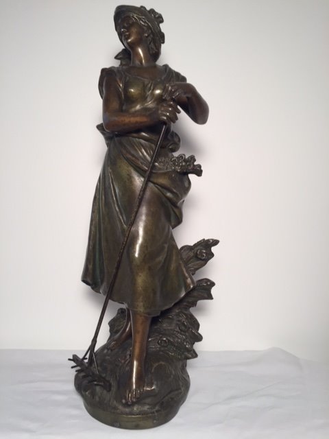 Auguste Moreau (1834-1917) - a statue of a female figure with a rake - spelter / zamac - late 19th century
