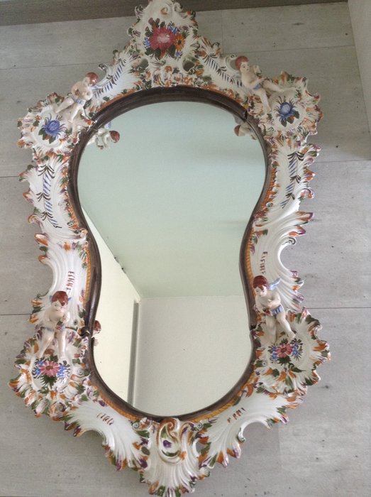 Mirror with porcelain ornaments