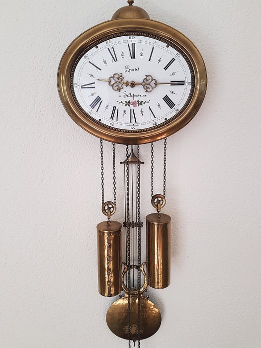 Oval wall clock model Comtoise -  Rousset à Bellefontaine - Brass - Second half 20th century
